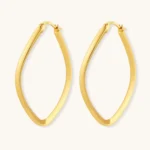 Set of geometric gold-plated sterling silver hoop earrings in oval and cushion shapes on cream background