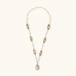 14K gold plated necklace with organic leaf motifs and freshwater pearls arranged in an elegant chain design on neutral background.