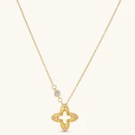18K gold-plated 925 silver necklace with open four-petal flower pendant, CZ accents, bezel-set stone on chain, white background.