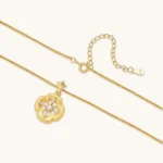 Gold-plated flower pendant necklace with brushed finish, open-work center, marquise CZ stones on wheat chain, S925 stamp.