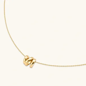 18K gold-plated 925 sterling silver letter N pendant on a delicate adjustable cable chain, cream background.