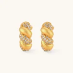 Pair of 18K gold-plated 925 silver huggie hoops with twisted braid texture and pavé cubic zirconia detailing, 15mm.
