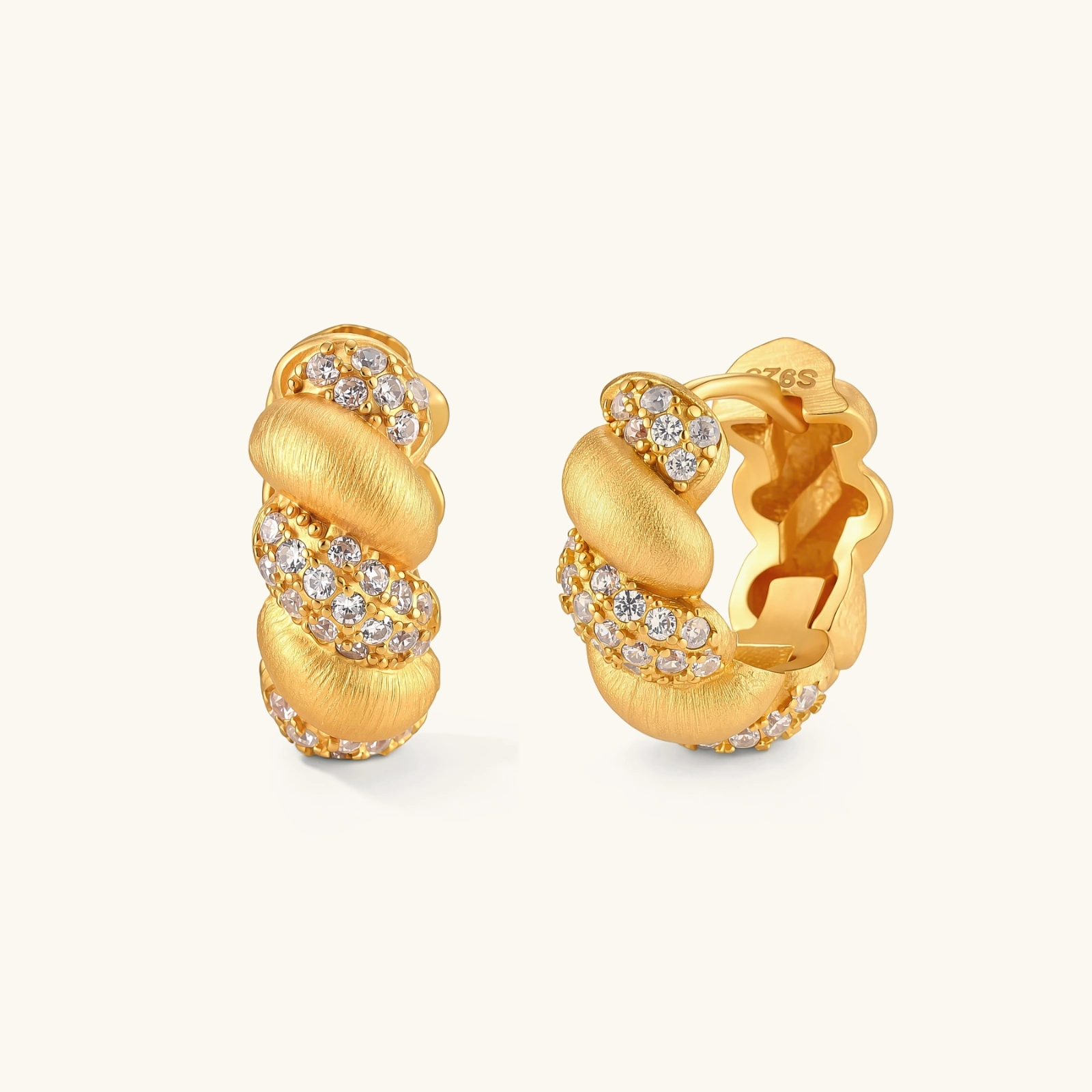313699758747828224.webp Pair of 18K gold-plated 925 silver huggie hoops with twisted braid texture and pavé cubic zirconia detailing, 15mm.