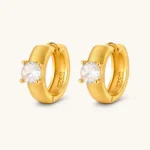 18K gold-plated 925 silver huggie hoops with brushed finish and prong-set round CZ solitaire, stamped S925 inside.