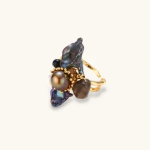 Adjustable gold-plated ring featuring clustered dark baroque pearls in organic arrangement on white background.
